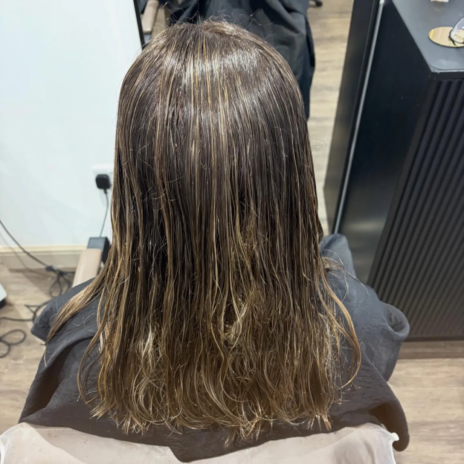 Rear view before: mid-brown shoulder-length hair, wet and undone after washing.