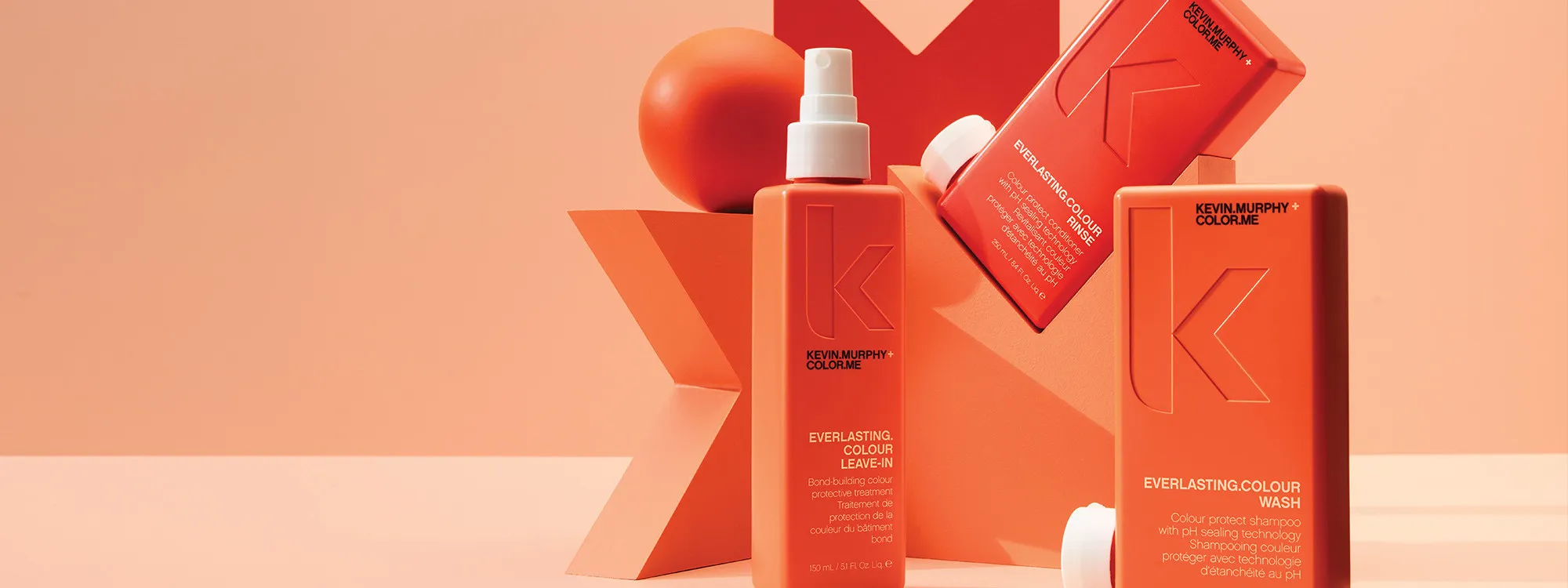 Kevin Murphy Everlasting Colour range: leave-in, rinse and wash bottles in coral.